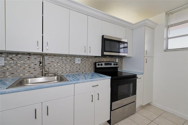 kitchen with white cabinets, appliances with stainless steel finishes, and tasteful backsplash