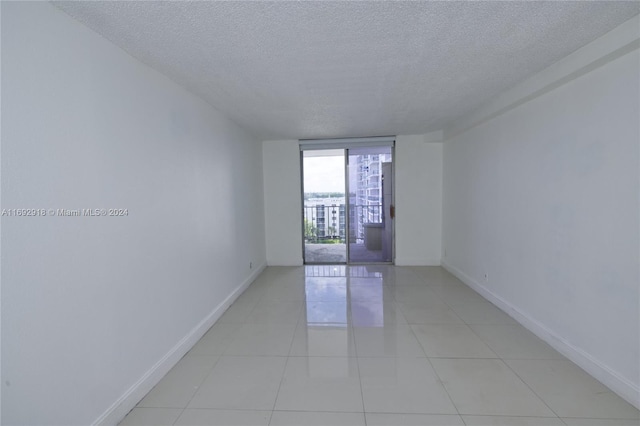 tiled spare room with a textured ceiling