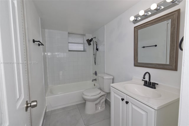 full bathroom featuring tile patterned flooring, vanity, tiled shower / bath combo, and toilet