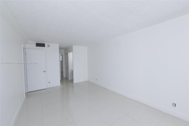 spare room with a textured ceiling