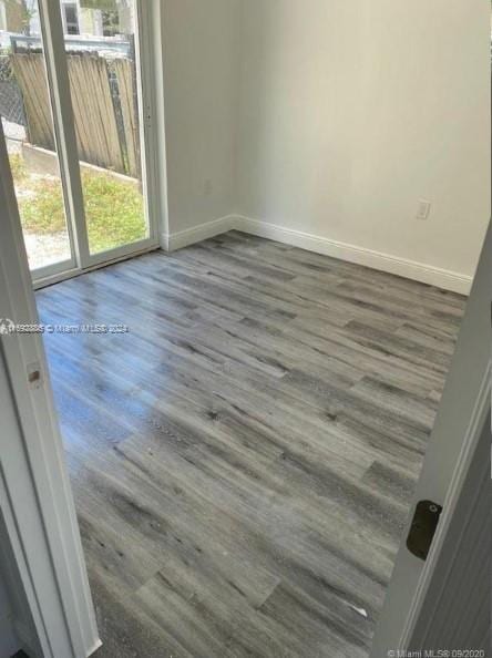 empty room featuring dark wood-type flooring