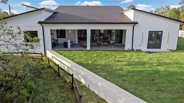 back of house with a patio area and a lawn