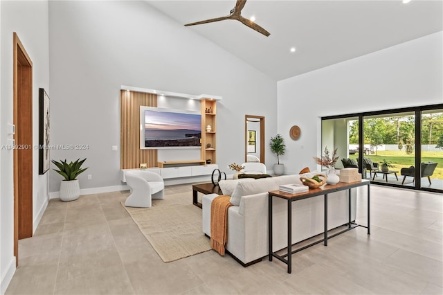 living room featuring high vaulted ceiling, ceiling fan, and light tile patterned flooring