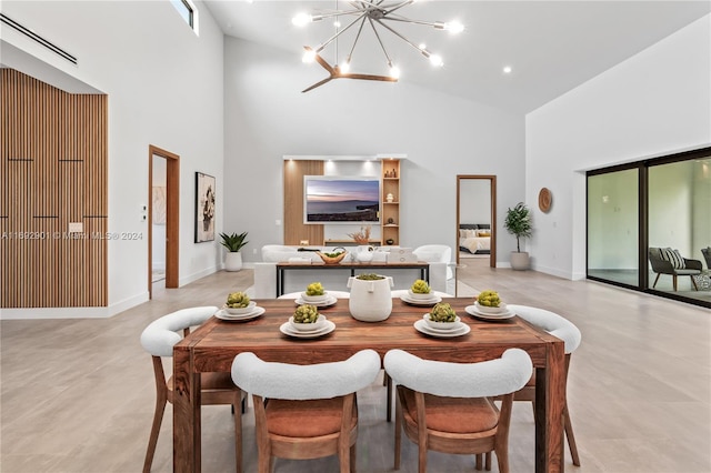 dining room with a chandelier and high vaulted ceiling