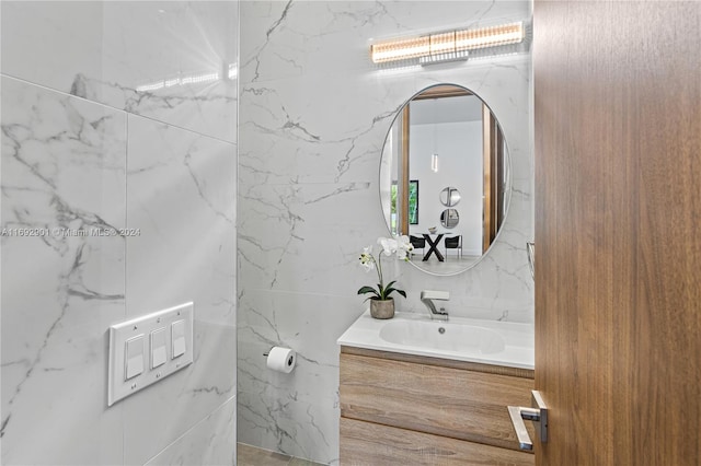 bathroom featuring tile walls and vanity