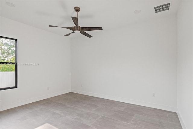 spare room with light tile patterned floors and ceiling fan