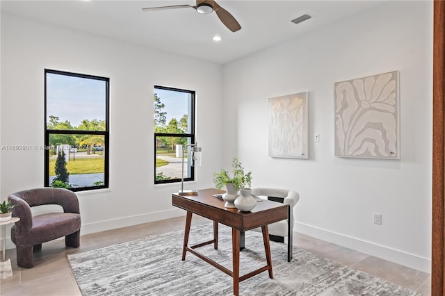 office space with ceiling fan and light tile patterned floors