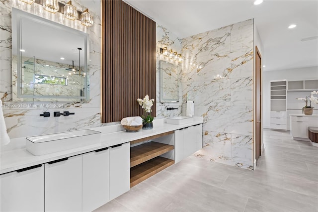 bathroom with vanity, tile walls, and a shower