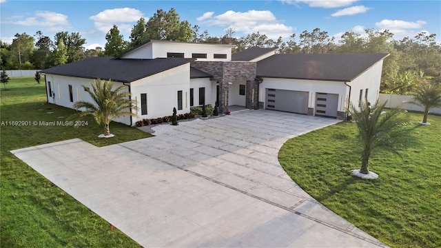 modern home featuring a garage and a front lawn