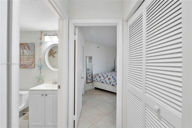 bedroom with light tile patterned floors and sink