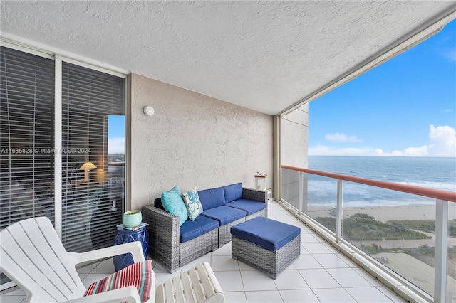 balcony with outdoor lounge area and a water view