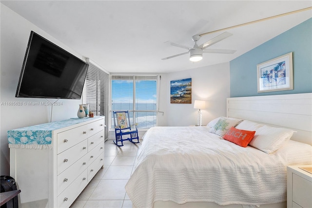 bedroom with ceiling fan and light tile patterned floors