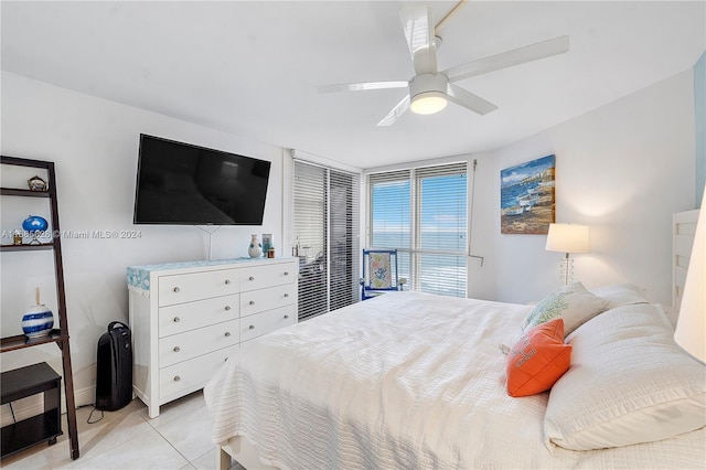 tiled bedroom featuring ceiling fan