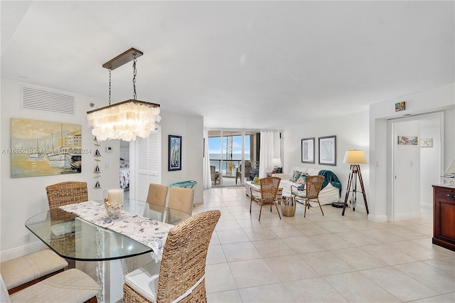 dining room with an inviting chandelier and light tile patterned flooring