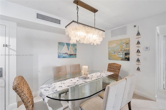 dining room with an inviting chandelier and light tile patterned flooring