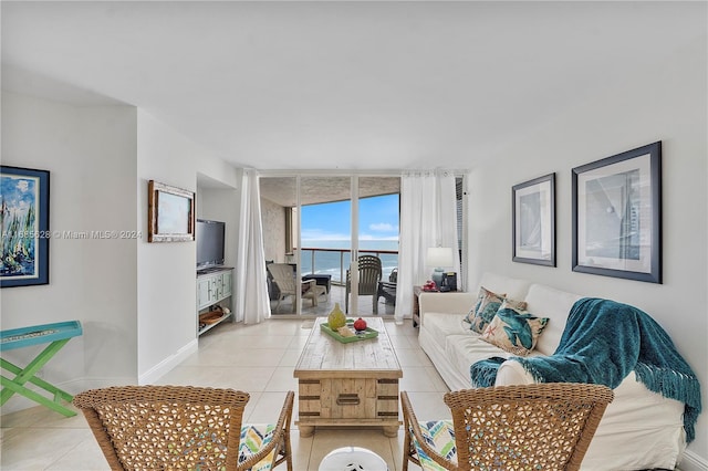 living room with expansive windows and light tile patterned flooring