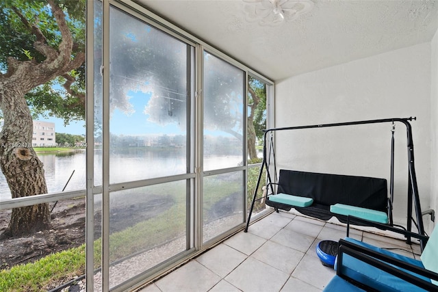 sunroom / solarium featuring a water view