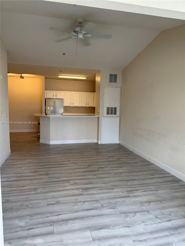 8239 Claire Ann Dr Unit 307, Orlando, FL 32825 - unfurnished living room with lofted ceiling, ceiling fan, and light hardwood / wood-style flooring
