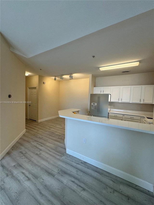 8239 Claire Ann Dr Unit 307, Orlando, FL 32825 - kitchen with white cabinets, light wood-type flooring, and high quality fridge