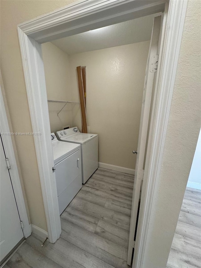 8239 Claire Ann Dr Unit 307, Orlando, FL 32825 - laundry area with washer and dryer and light hardwood / wood-style flooring