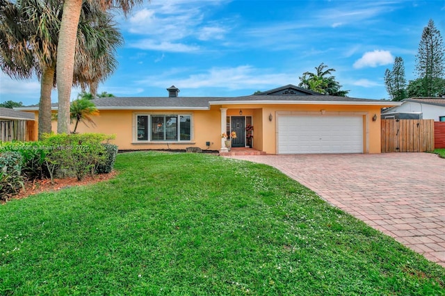 single story home with a garage and a front lawn