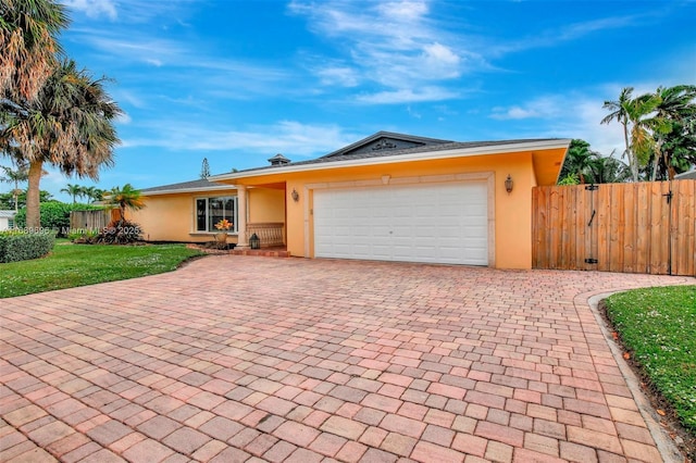 single story home featuring a front yard and a garage