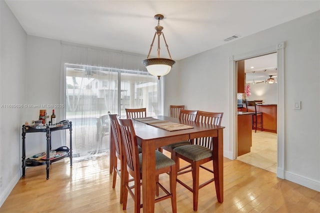 dining space with light hardwood / wood-style flooring