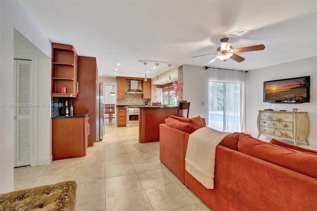 tiled living room with ceiling fan