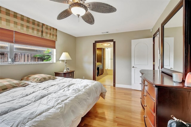 bedroom with ceiling fan, ensuite bathroom, and light hardwood / wood-style floors