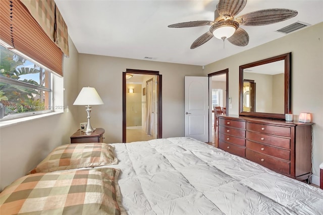 bedroom featuring ensuite bath and ceiling fan