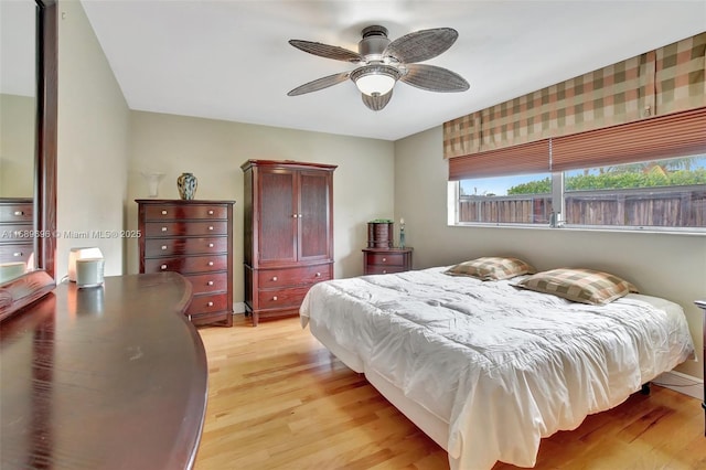 bedroom with ceiling fan and light hardwood / wood-style floors