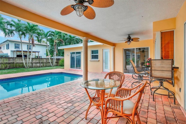 view of swimming pool featuring a patio area and ceiling fan