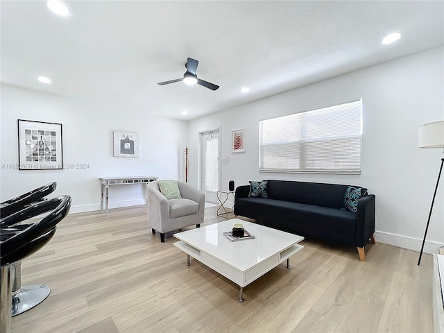 living room featuring ceiling fan and light hardwood / wood-style flooring