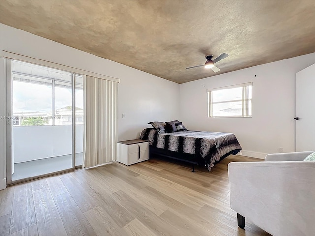 bedroom featuring access to exterior, ceiling fan, and light hardwood / wood-style floors