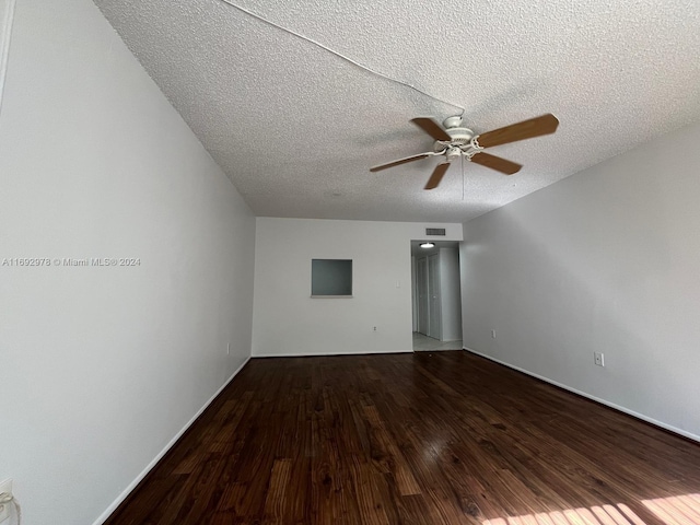 spare room featuring ceiling fan, hardwood / wood-style floors, and a textured ceiling