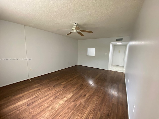 spare room featuring hardwood / wood-style flooring, ceiling fan, and a textured ceiling