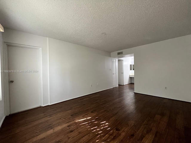 4344 NW 9th Ave Unit 9-3D, Deerfield Beach, FL 33064 - unfurnished room with dark wood-style floors and a textured ceiling
