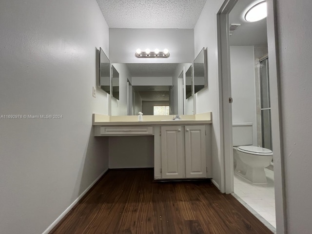 4344 NW 9th Ave Unit 9-3D, Deerfield Beach, FL 33064 - bathroom featuring hardwood / wood-style flooring, vanity, a textured ceiling, and a shower with shower door