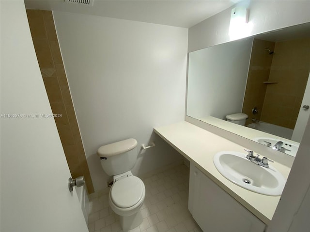 full bathroom featuring toilet, vanity, tile patterned floors, and tiled shower / bath combo