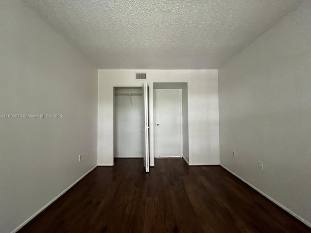 4344 NW 9th Ave Unit 9-3D, Deerfield Beach, FL 33064 - unfurnished bedroom with wood finished floors and a textured ceiling