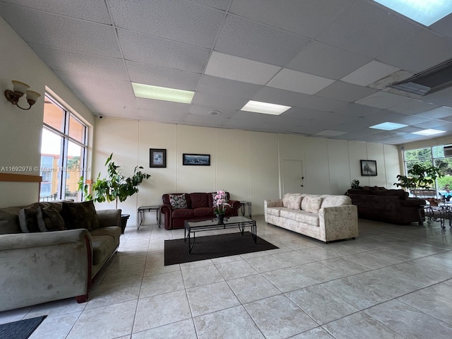 interior space featuring a drop ceiling and light tile patterned flooring