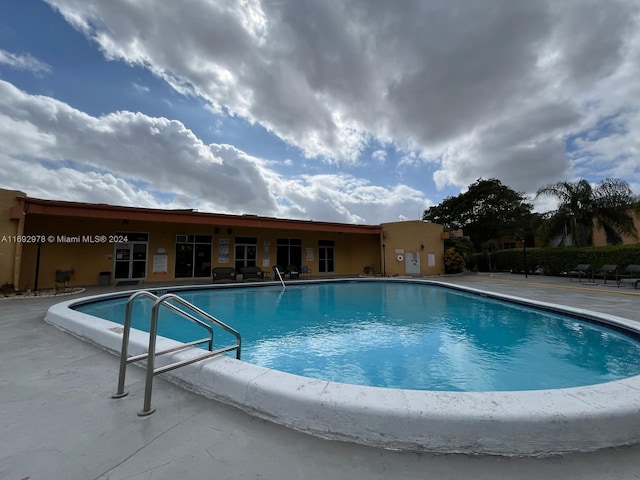 view of swimming pool with a patio