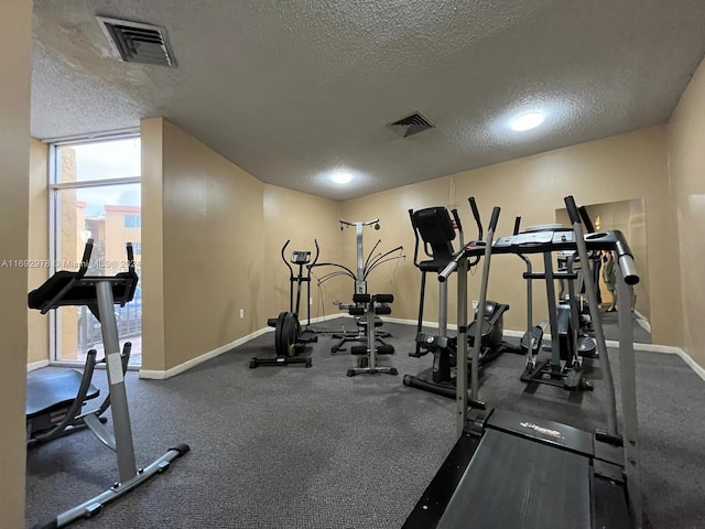 exercise room with a textured ceiling