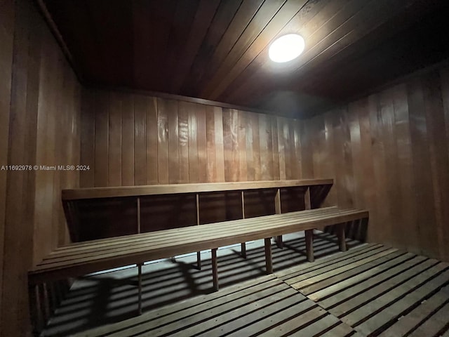 view of sauna / steam room featuring wood ceiling and wood walls