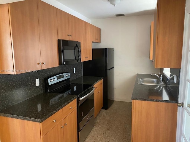 kitchen featuring dark stone countertops, stainless steel electric range oven, sink, and tasteful backsplash