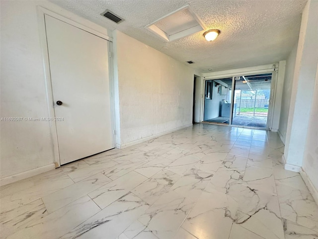 spare room with a textured ceiling