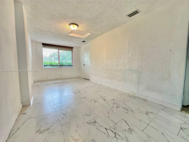 spare room featuring a textured ceiling