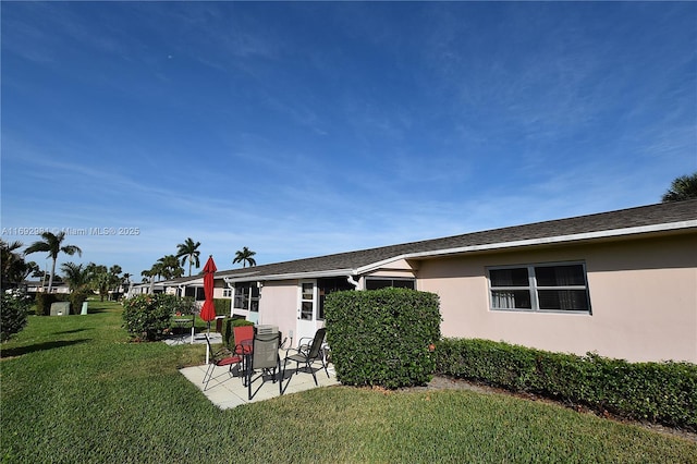 2688 E Dudley Dr Unit H, West Palm Beach, FL 33415 - back of house with a patio, a yard, and stucco siding