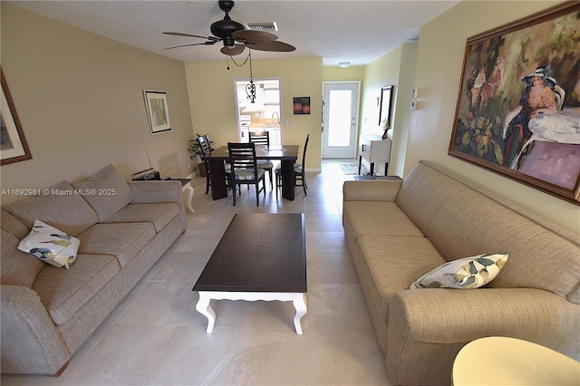 2688 E Dudley Dr Unit H, West Palm Beach, FL 33415 - tiled living room with a ceiling fan and a textured ceiling