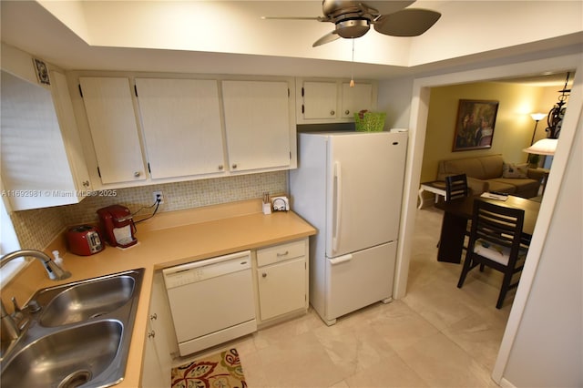 kitchen with backsplash, ceiling fan, sink, and white appliances